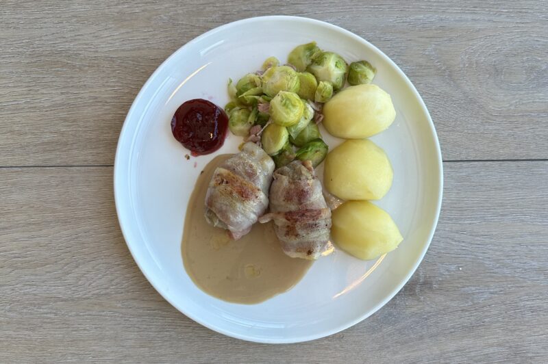 Middagsretten beinlause fuglar med rosenkål, potet, fløytesaus og tyttebærsyltetøy på ein kvit tallerken